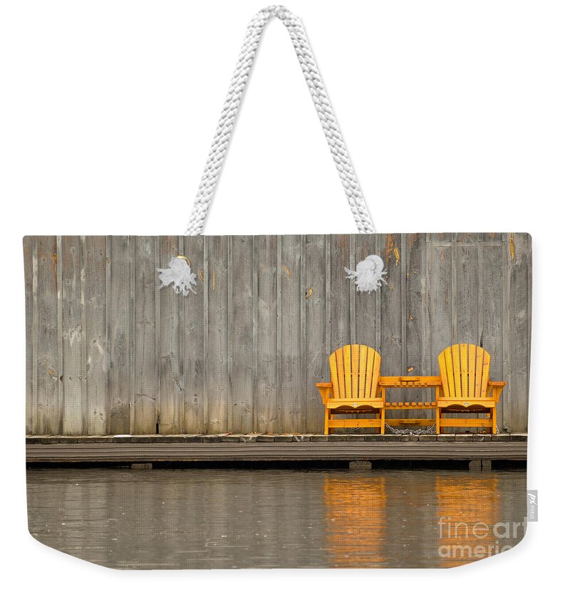 Two Weekender Tote Bag featuring the photograph Two wooden chairs on an old dock by Les Palenik