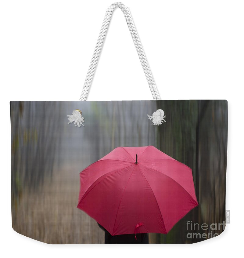 Woman Weekender Tote Bag featuring the photograph Umbrella and blur by Mats Silvan