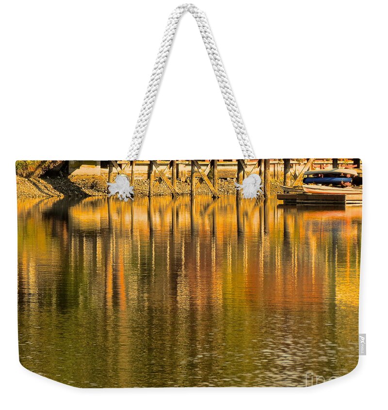 Boat Weekender Tote Bag featuring the photograph Under the dock by LeLa Becker
