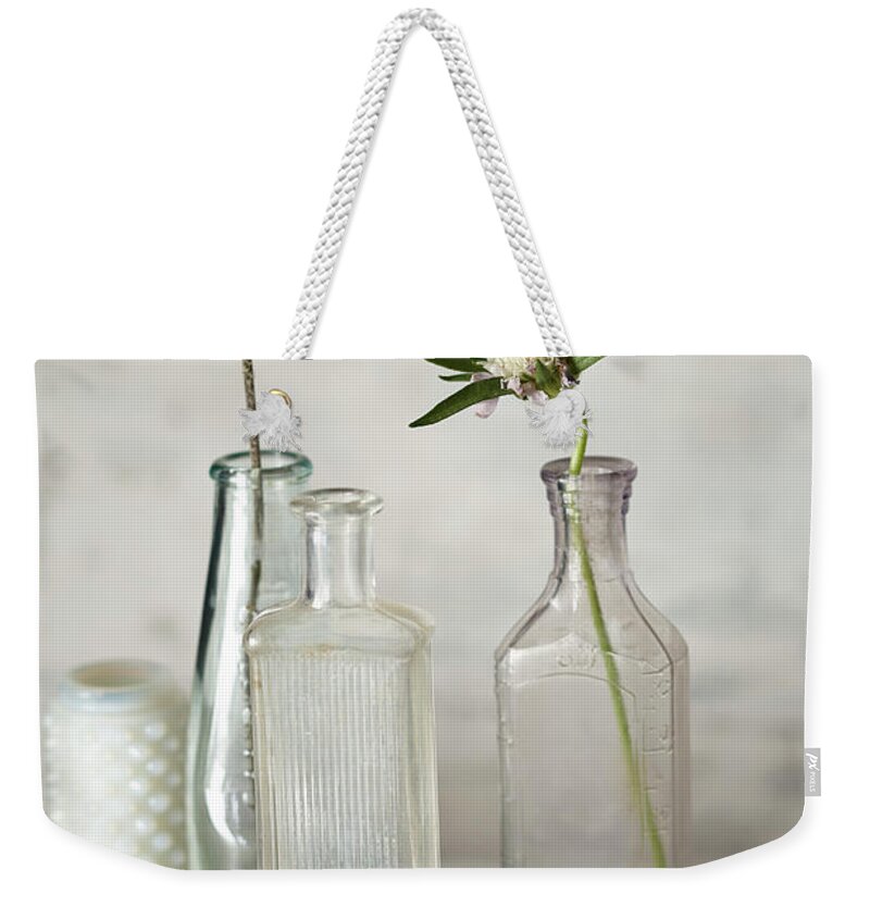 Fragility Weekender Tote Bag featuring the photograph Vintage Bottles And Flowers by Lew Robertson