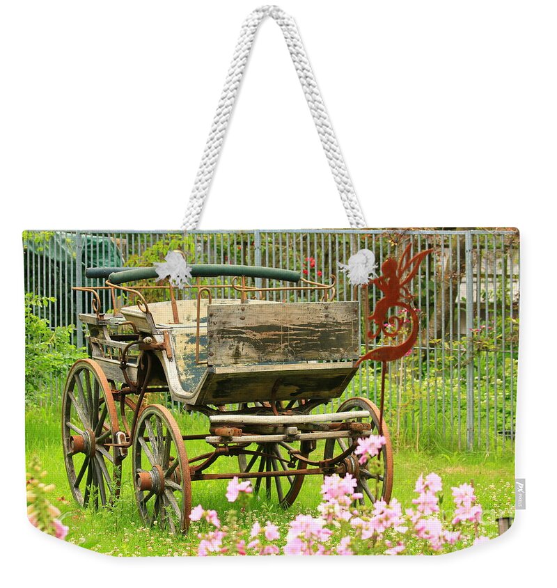 Aged Weekender Tote Bag featuring the photograph Vintage horse carriage in a flower bed by Amanda Mohler