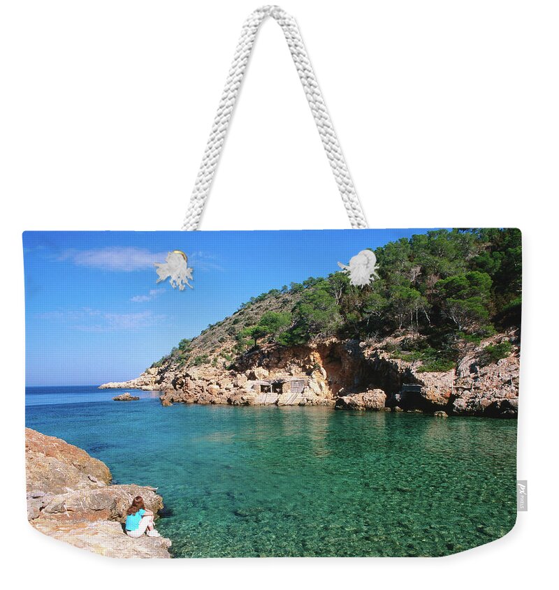 Shadow Weekender Tote Bag featuring the photograph Waters Of Cala Xucla With Girl On Rocks by David C Tomlinson
