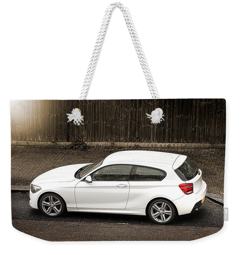 Street Weekender Tote Bag featuring the photograph White hatchback car by Dutourdumonde Photography