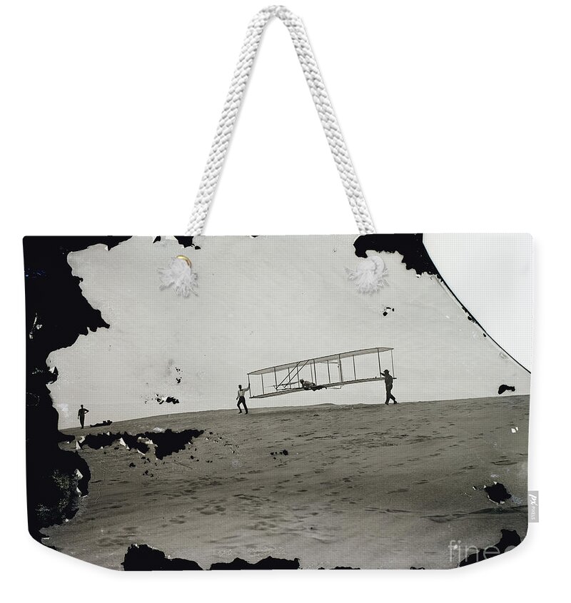 The Wright Brothers Weekender Tote Bag featuring the photograph The Wright Brothers Wilbur in motion at left holding one end of glider by Vintage Collectables
