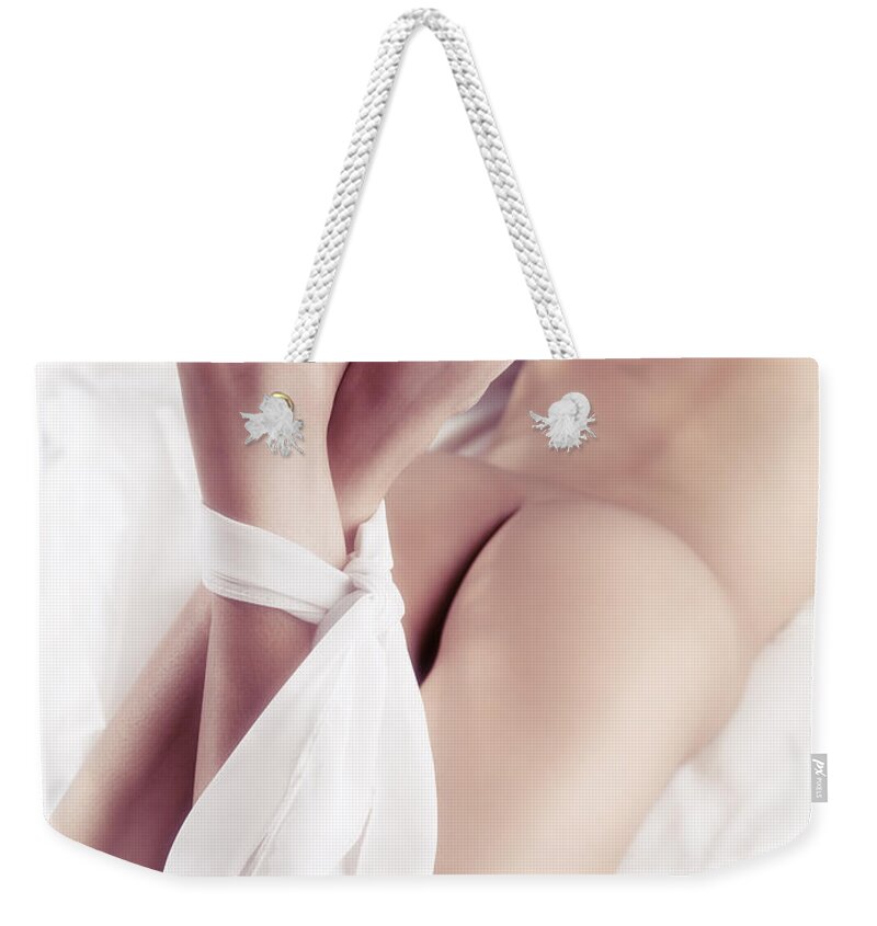 Woman Weekender Tote Bag featuring the photograph Woman legs tied with a scarf by Maxim Images Exquisite Prints