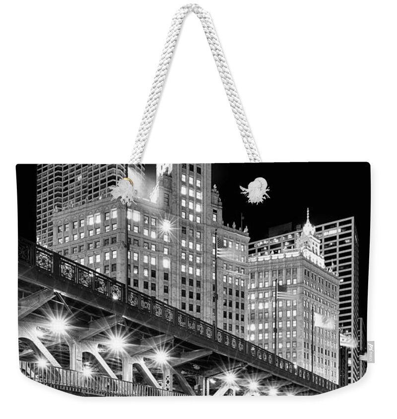 Dusk Weekender Tote Bag featuring the photograph Wrigley Building at Night in Black and White by Sebastian Musial