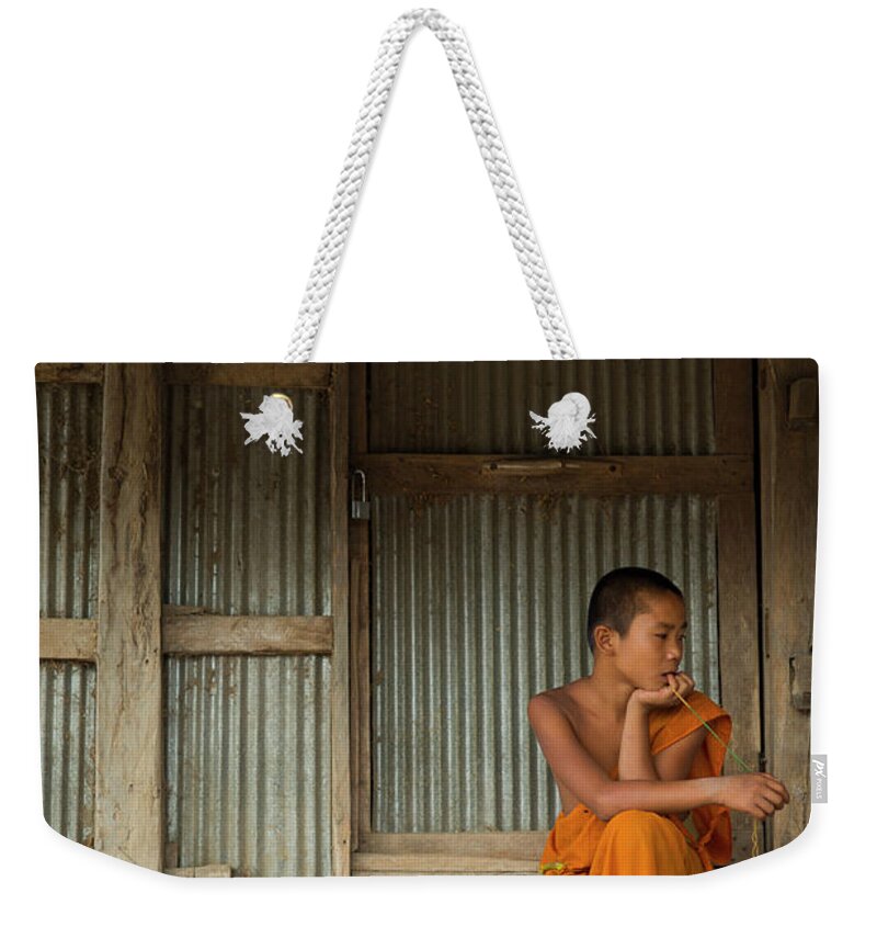 Orange Color Weekender Tote Bag featuring the photograph Young Buddhist Monk, Kengtung, Shan by Cultura Rm Exclusive/yellowdog
