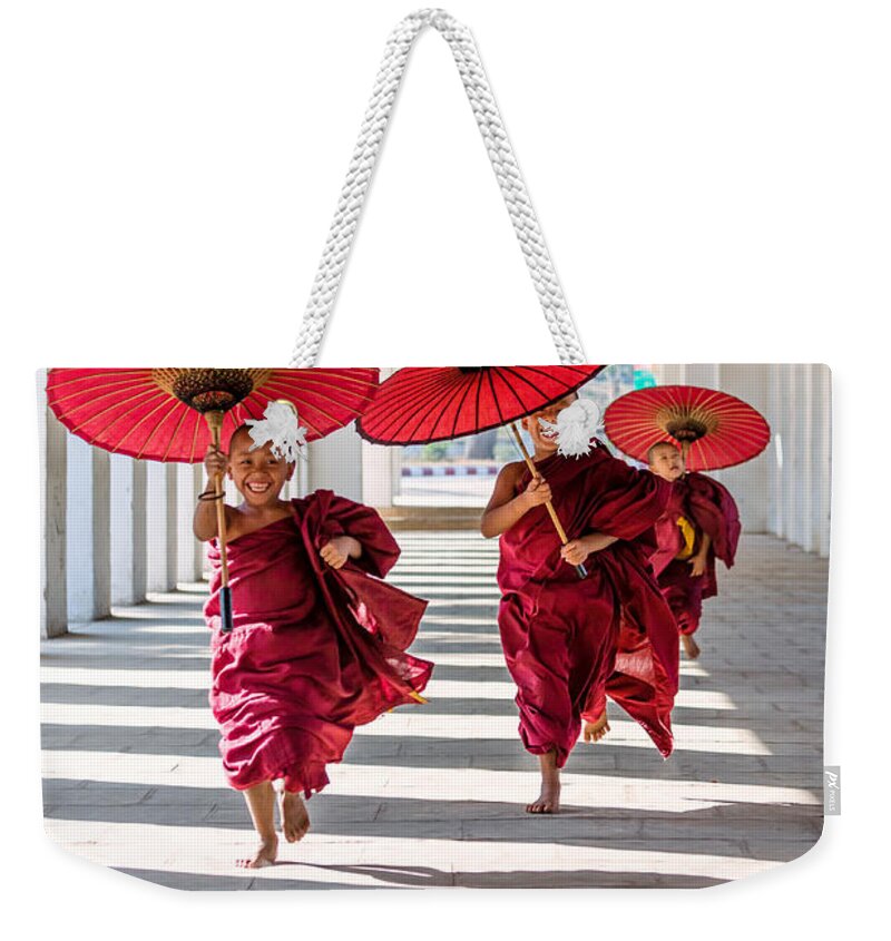 Children Weekender Tote Bag featuring the photograph Young buddhist monks on the run - Myanmar by Matteo Colombo