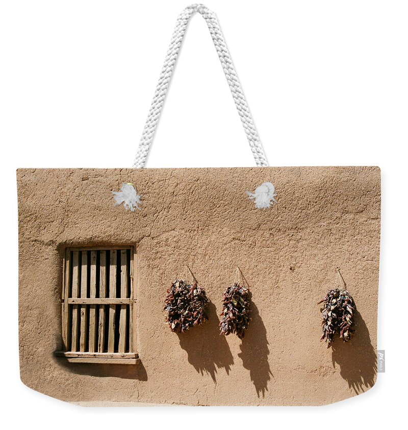Santa Fe Weekender Tote Bag featuring the photograph Ristras On Adobe Wall by Ron Weathers