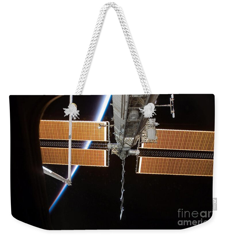 Nasa Weekender Tote Bag featuring the photograph Iss Solar Array #1 by Nasa