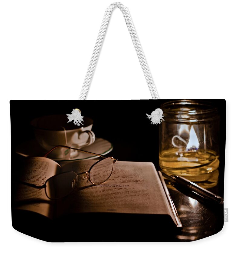 Book Weekender Tote Bag featuring the photograph A Candlelight Scene by Lori Coleman