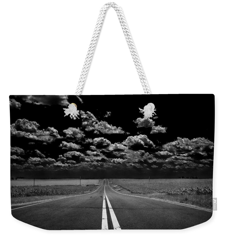 Road Weekender Tote Bag featuring the photograph A Long Dark Road by Bill and Linda Tiepelman