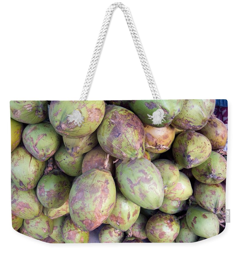 Tender Weekender Tote Bag featuring the photograph A number of tender raw coconuts in a pile by Ashish Agarwal