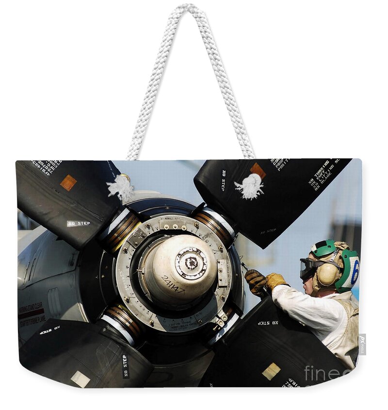 Color Image Weekender Tote Bag featuring the photograph A Sailor Performs Maintenance by Stocktrek Images