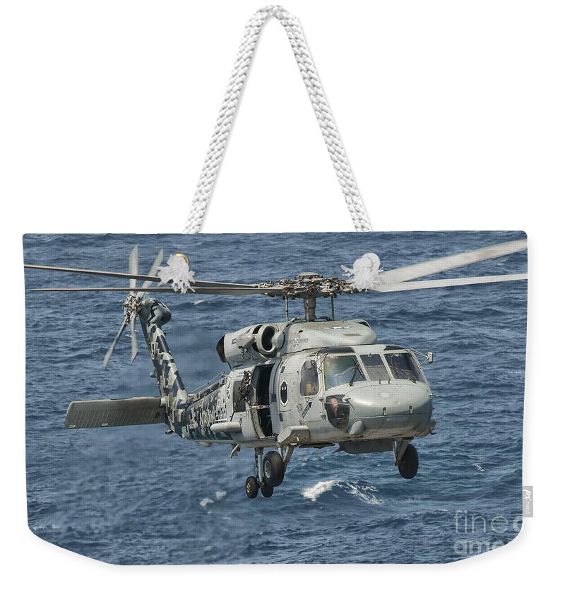 Arabian Sea Weekender Tote Bag featuring the photograph A Us Navy Sh-60f Seahawk Flying by Giovanni Colla