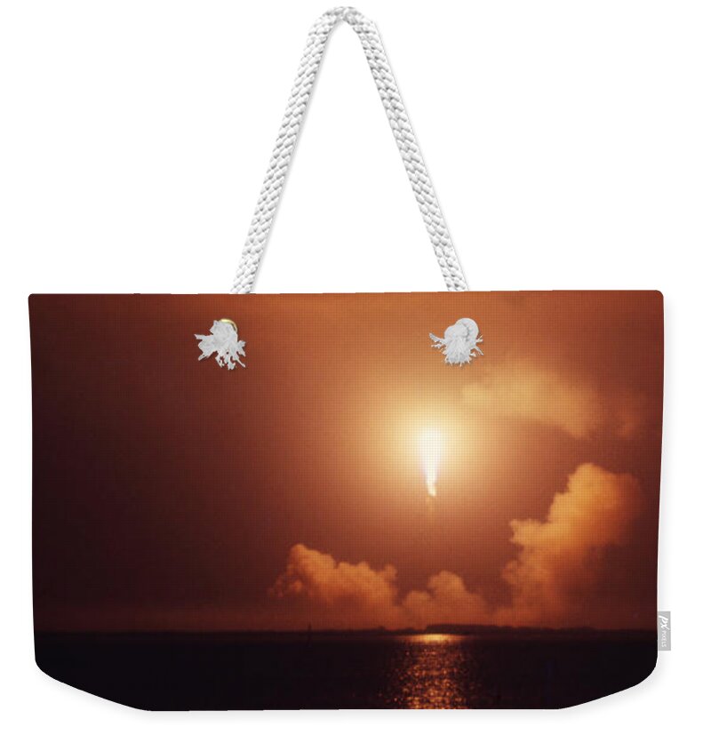 Space Weekender Tote Bag featuring the painting Apollo 17 Carrying The Fire by Don Dixon