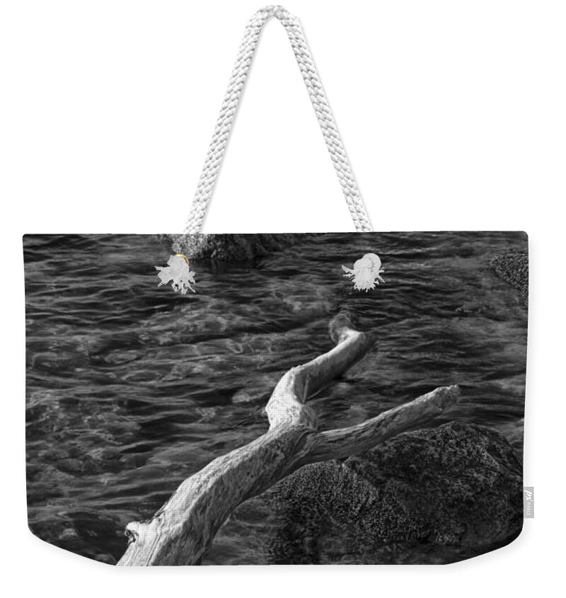 Boat Weekender Tote Bag featuring the photograph Black and White Photograph of a row boat anchored near a rocky shore by Randall Nyhof