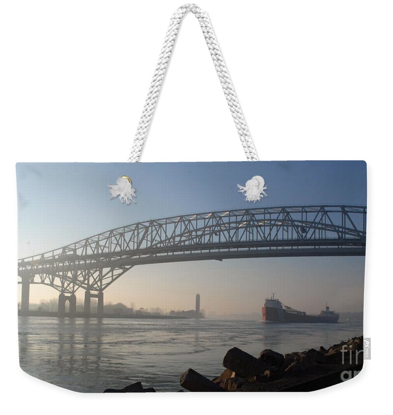 Bridge Weekender Tote Bag featuring the photograph Blue Water Bridges and Ship Headed North by Ronald Grogan