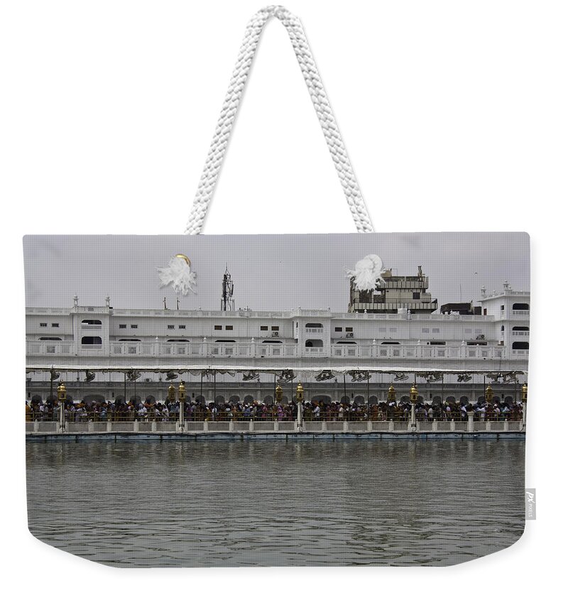 Amrit Sarovar Weekender Tote Bag featuring the photograph Crowd of devotees inside the Golden Temple by Ashish Agarwal