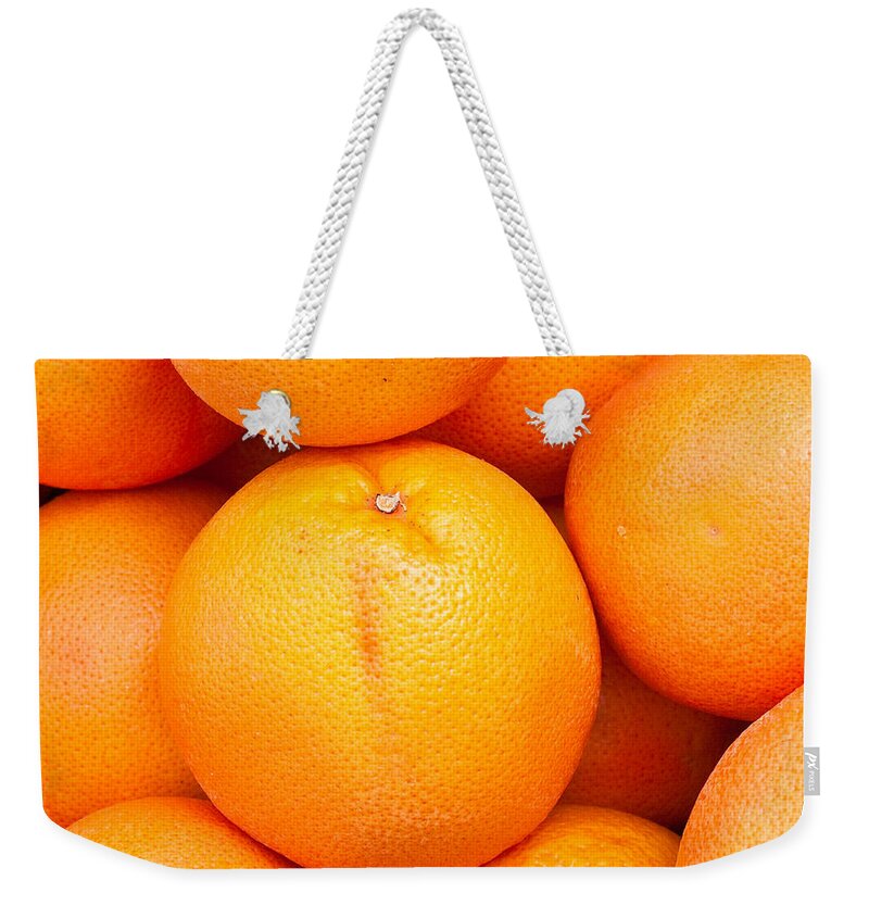 Background Weekender Tote Bag featuring the photograph Grapefruit by Tom Gowanlock