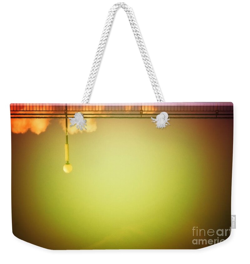 Abstract Weekender Tote Bag featuring the photograph Lamp and clouds in a swimming pool by Silvia Ganora