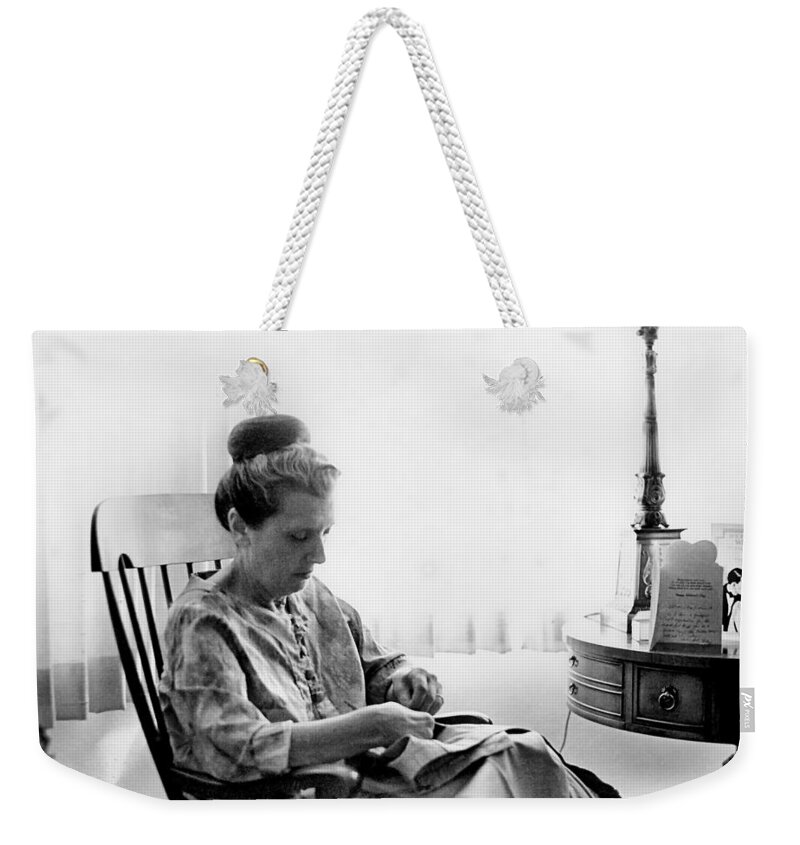 Woman Weekender Tote Bag featuring the photograph Mending More Than Clothes by Rory Siegel