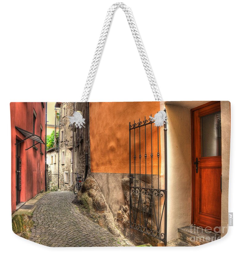 Alley Weekender Tote Bag featuring the photograph Old colorful rustic alley by Mats Silvan