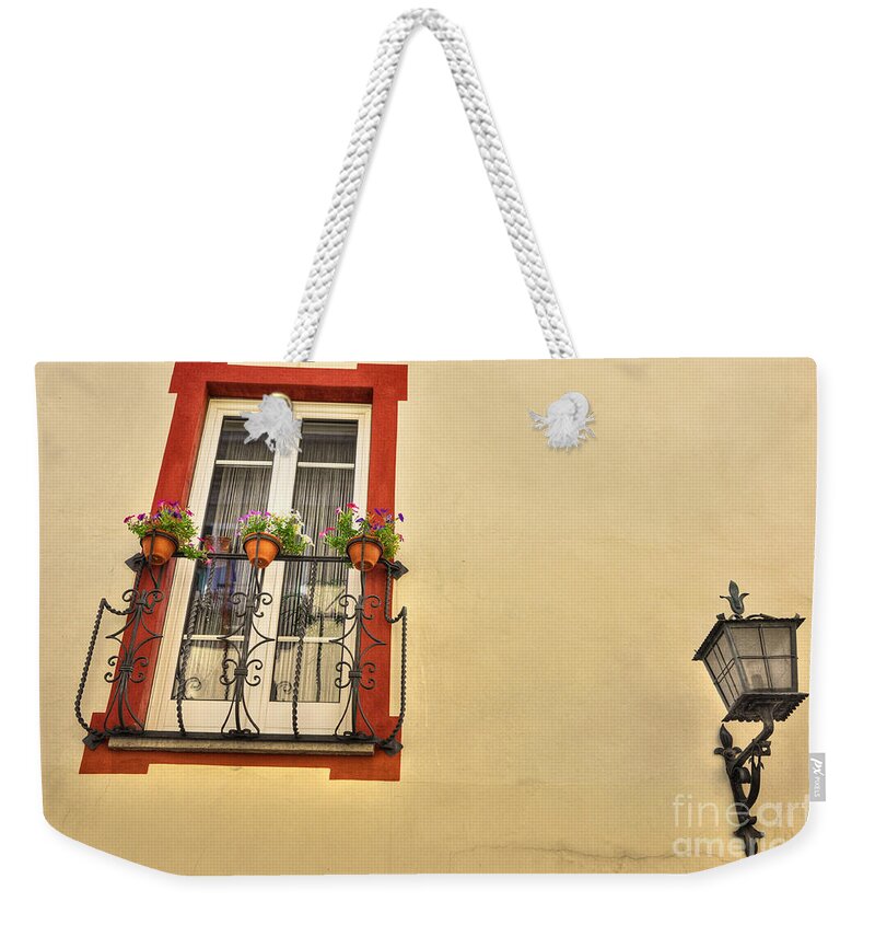 Window Weekender Tote Bag featuring the photograph Old window and a street lamp by Mats Silvan
