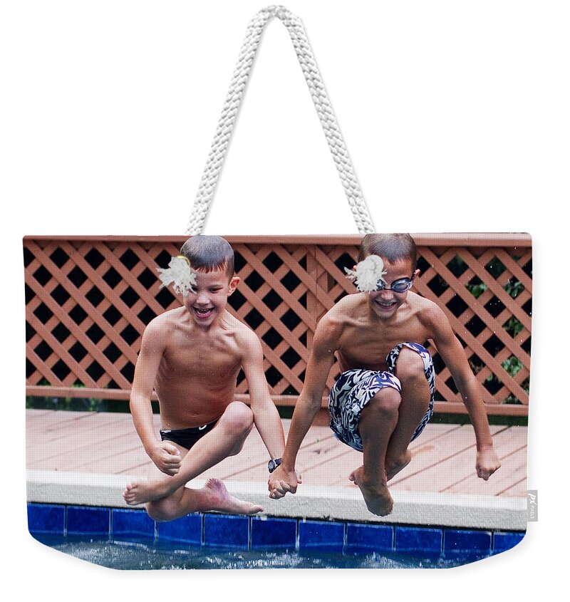 Synchronized Weekender Tote Bag featuring the photograph Synchronized Cannonballs by Farol Tomson