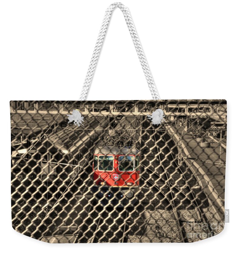Train Weekender Tote Bag featuring the photograph Train behind a fence by Mats Silvan