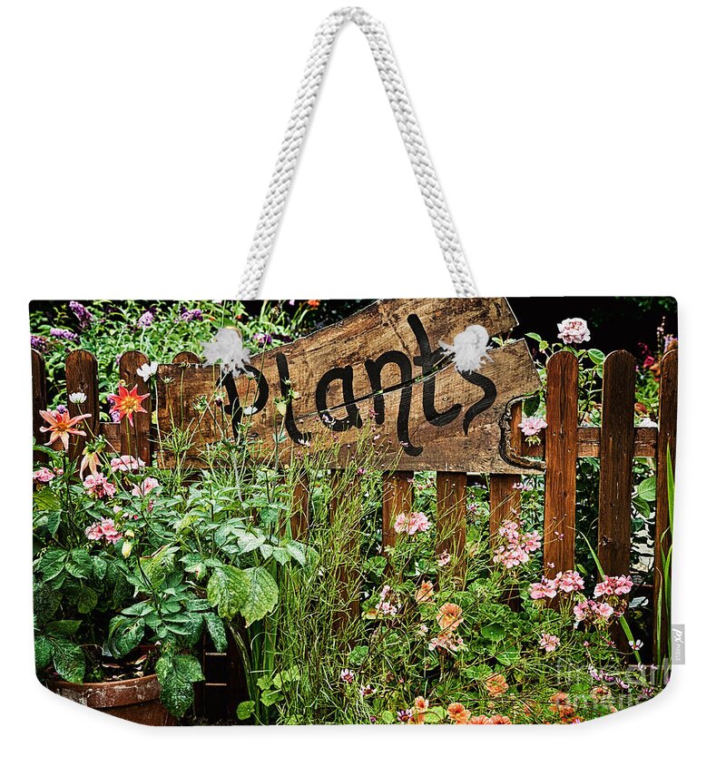 Plants Weekender Tote Bag featuring the photograph Wooden plant sign in flowers by Simon Bratt