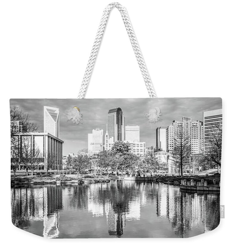 America Weekender Tote Bag featuring the photograph Charlotte Skyline Reflection on Marshall Park Pond #1 by Paul Velgos