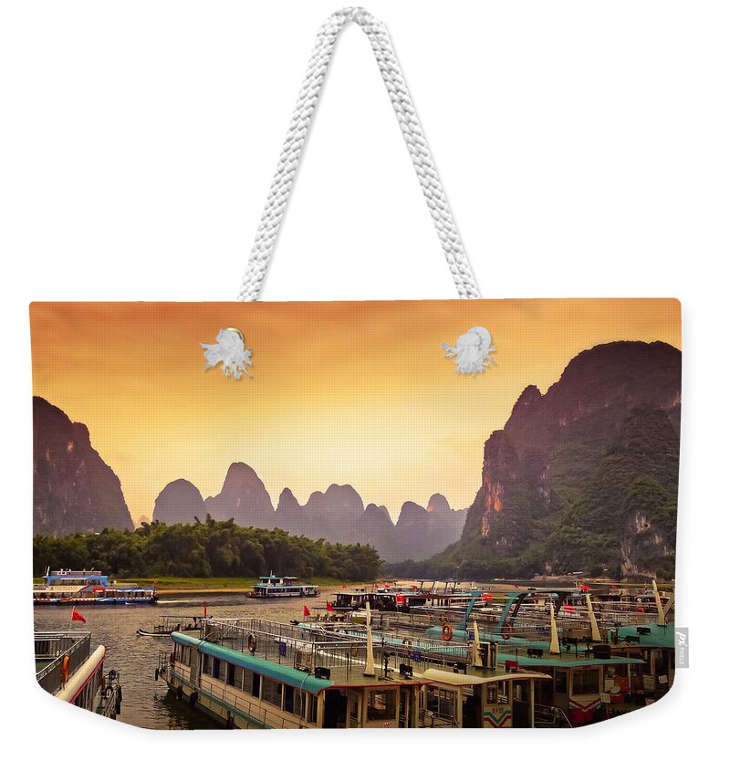 Sunset Weekender Tote Bag featuring the photograph Boat watching the sun goes down-China Guilin scenery-Lijiang River in Yangshuo by Artto Pan