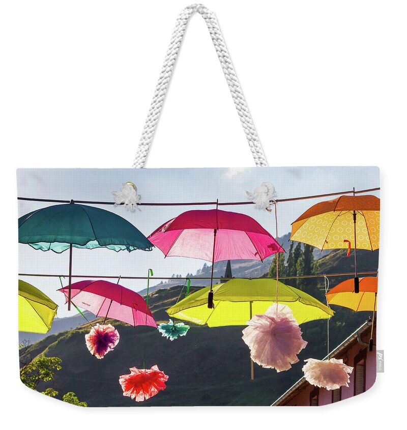 Umbrella Weekender Tote Bag featuring the photograph Colored umbrellas # II by Paul MAURICE