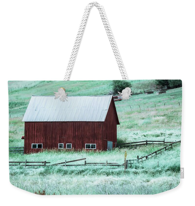 Red Weekender Tote Bag featuring the photograph landscape with a red barn in rural Montana and Rocky Mountains #1 by Alex Grichenko
