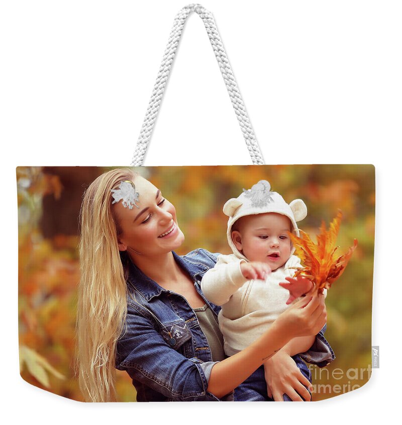 Autumn Weekender Tote Bag featuring the photograph Mother with son enjoying autumn #1 by Anna Om