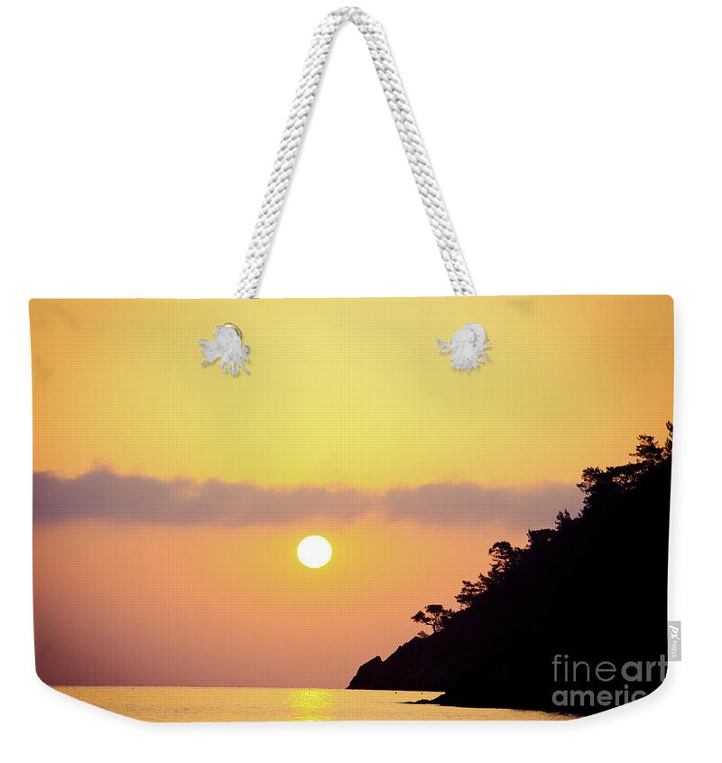 Sunset Weekender Tote Bag featuring the photograph Orange sunrise above sea #1 by Raimond Klavins