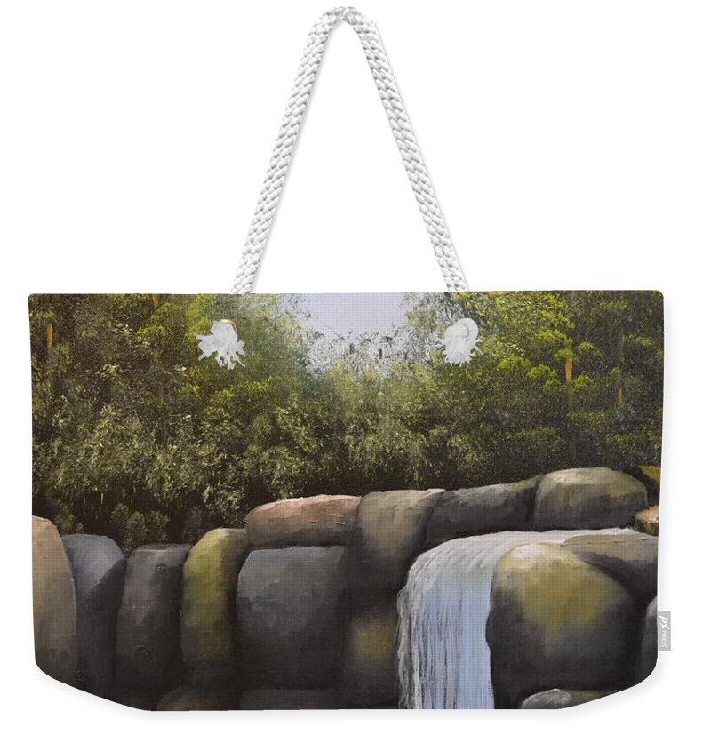 A Painting Of A Waterfalls In A Forest With Large Boulders. There Is A Blue Cloudless Sky And The Forest Trees Have Very Dense Green Leaves. The Large Boulders Are Different Colors And The Small Lake Water Is Dark In Color. Weekender Tote Bag featuring the painting Rocky Falls by Martin Schmidt