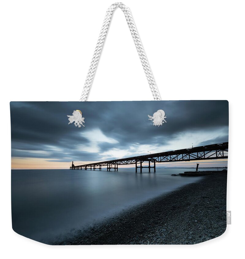 Pier Weekender Tote Bag featuring the photograph Seascape with jetty during a dramatic cloudy sunset #3 by Michalakis Ppalis