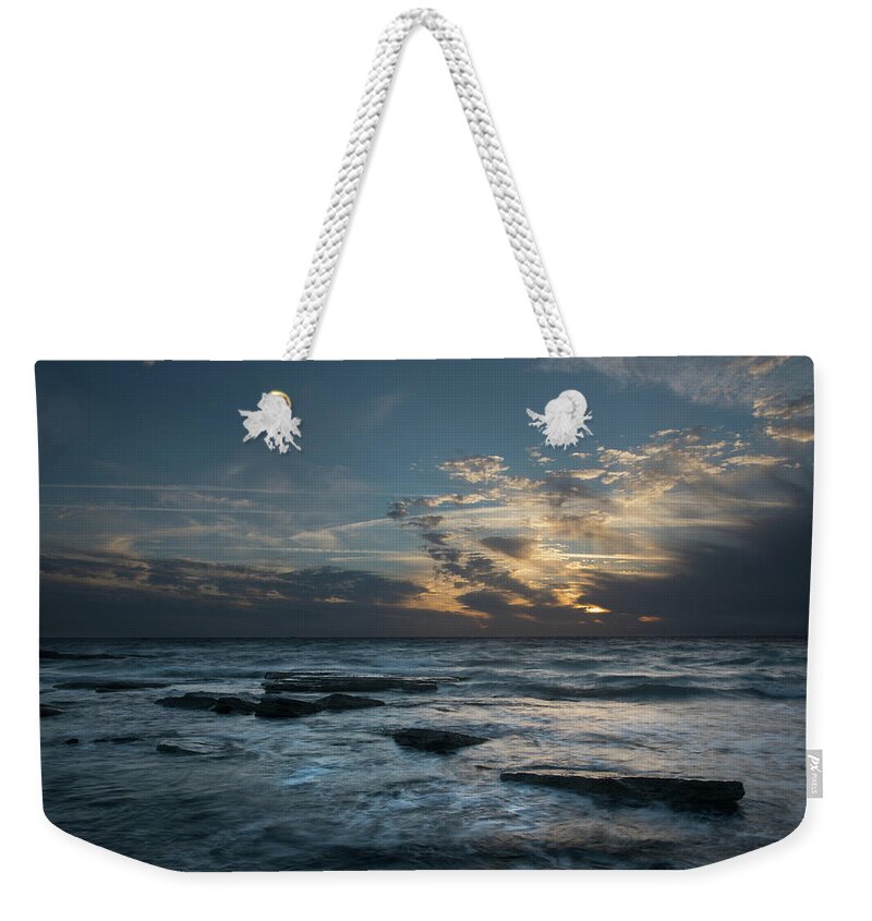 Sunset Over Sea Weekender Tote Bag featuring the photograph Sunset on a rocky beach by Michalakis Ppalis