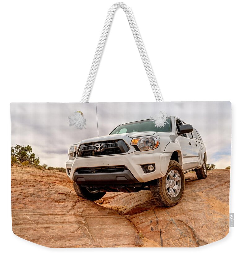 4 Wheel Drive Weekender Tote Bag featuring the photograph Toyota Tacoma at Arches #1 by Brett Engle