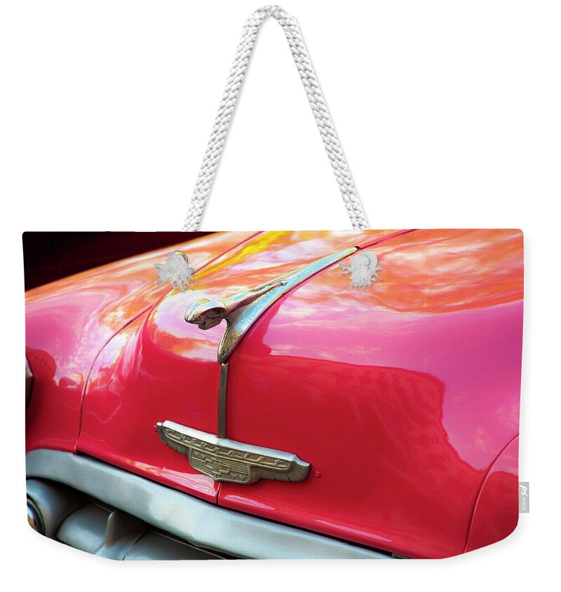 Vintage Chevy Hood Ornament Havana Cuba Photography By Charles Harden Glossy Polished Chrome Chevrolet Weekender Tote Bag featuring the photograph Vintage Chevy Hood Ornament Havana Cuba #3 by Charles Harden