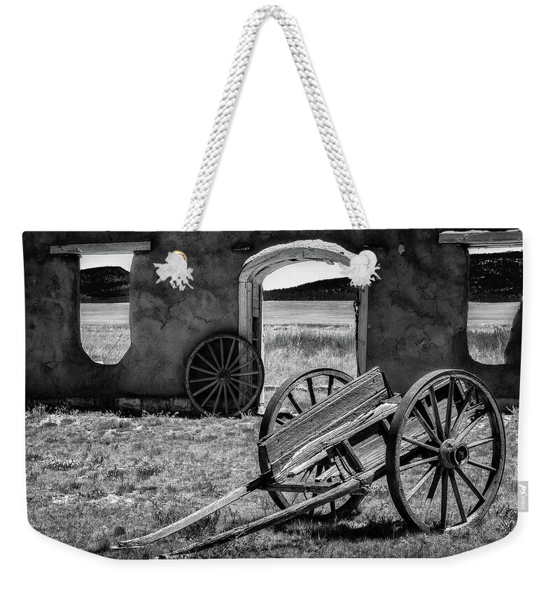 New Mexico Weekender Tote Bag featuring the photograph Wagon Wheels in bw by James Barber