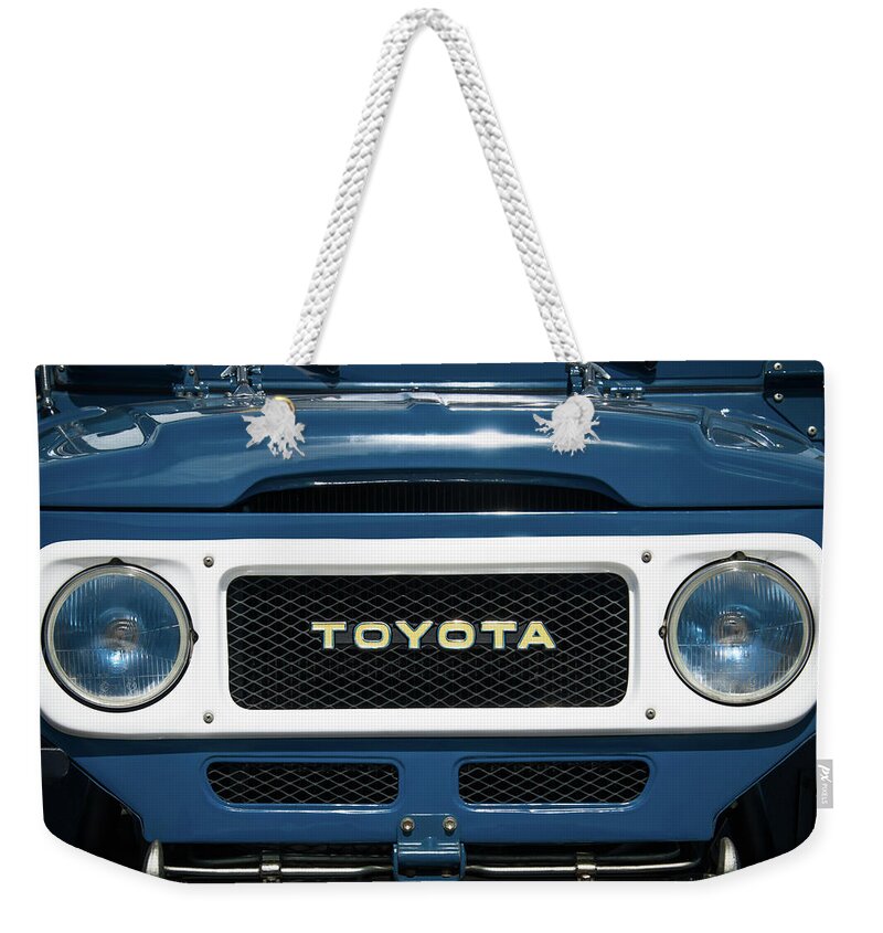 1982 Toyota Fj43 Land Cruiser Grille Emblem Weekender Tote Bag featuring the photograph 1982 Toyota FJ43 Land Cruiser Grille Emblem -0522c by Jill Reger