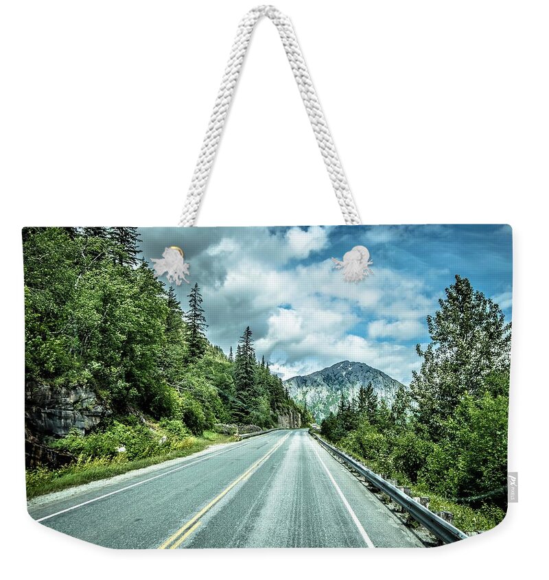 Road Weekender Tote Bag featuring the photograph The White Pass and Yukon Route on train passing through vast lan #34 by Alex Grichenko