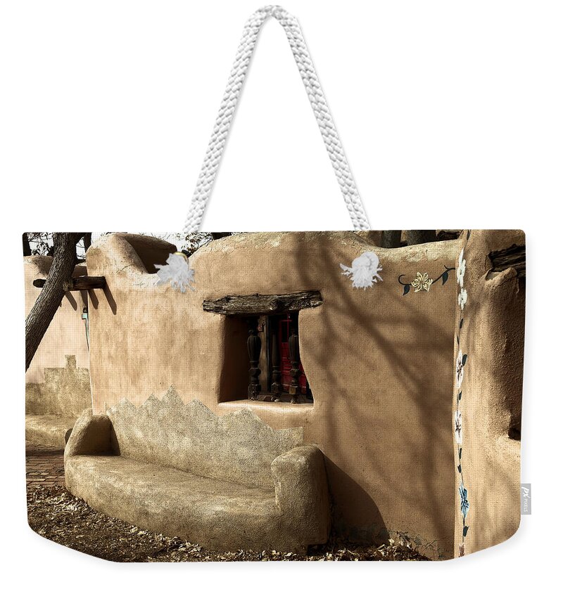 New Mexico Weekender Tote Bag featuring the photograph A bench in old town by Jeff Swan