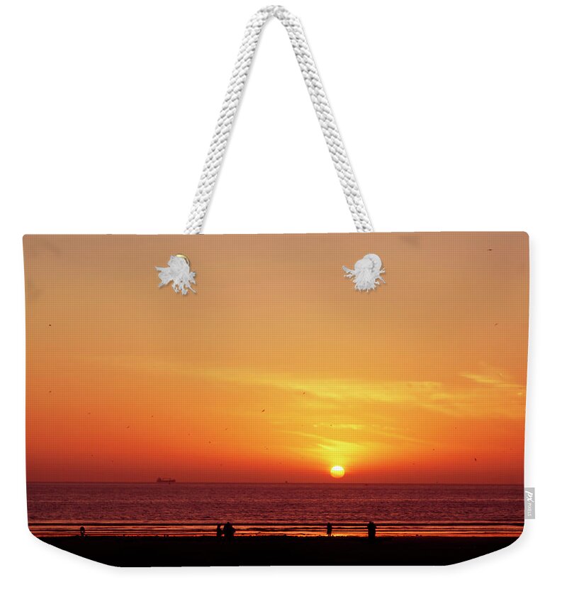 Africa Weekender Tote Bag featuring the photograph A gorgeous sundown with view to the sea by Gina Koch