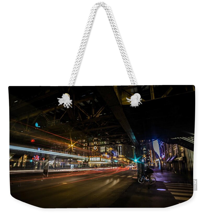 State Weekender Tote Bag featuring the photograph a nighttime look at Chicago's busy State and Lake Intersection by Sven Brogren