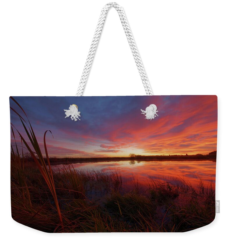 Sunset Weekender Tote Bag featuring the photograph A Prairie Pothole by Dan Jurak