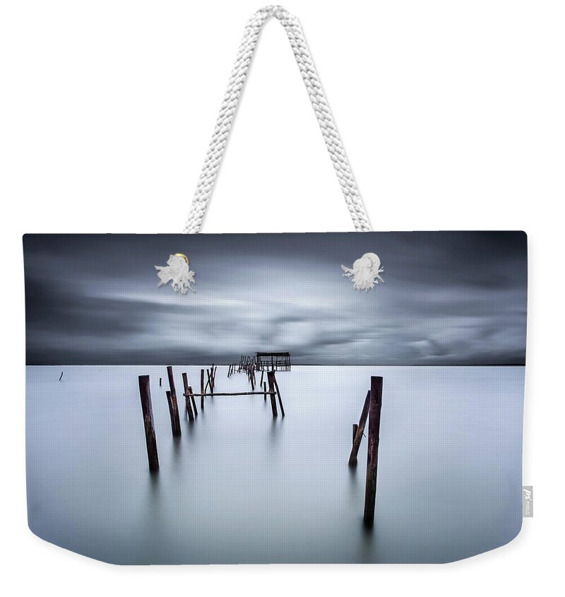 Pier Weekender Tote Bag featuring the photograph A test of time by Jorge Maia